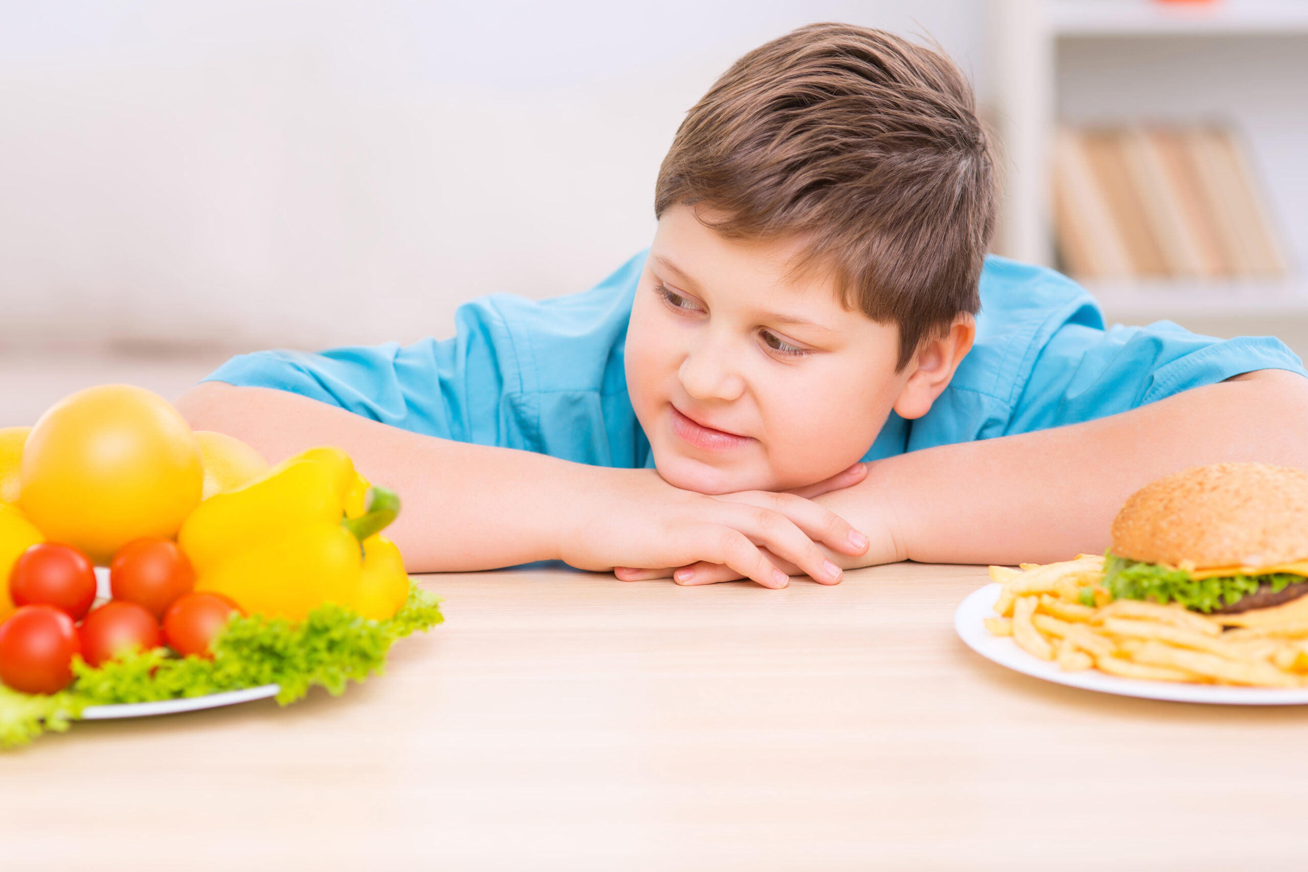 Child looking at a plate of healthy food