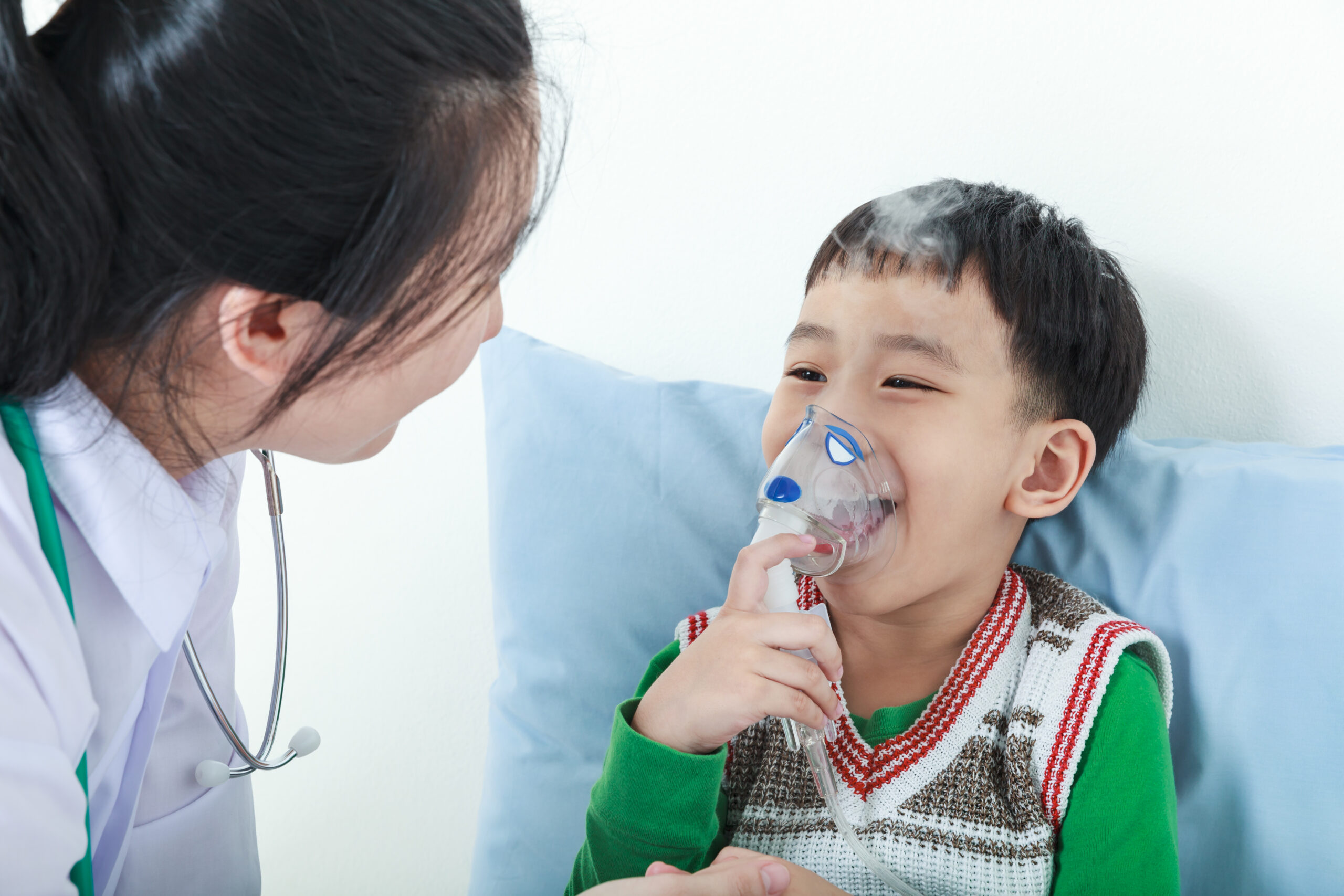 Child using an inhaler with a doctor's help