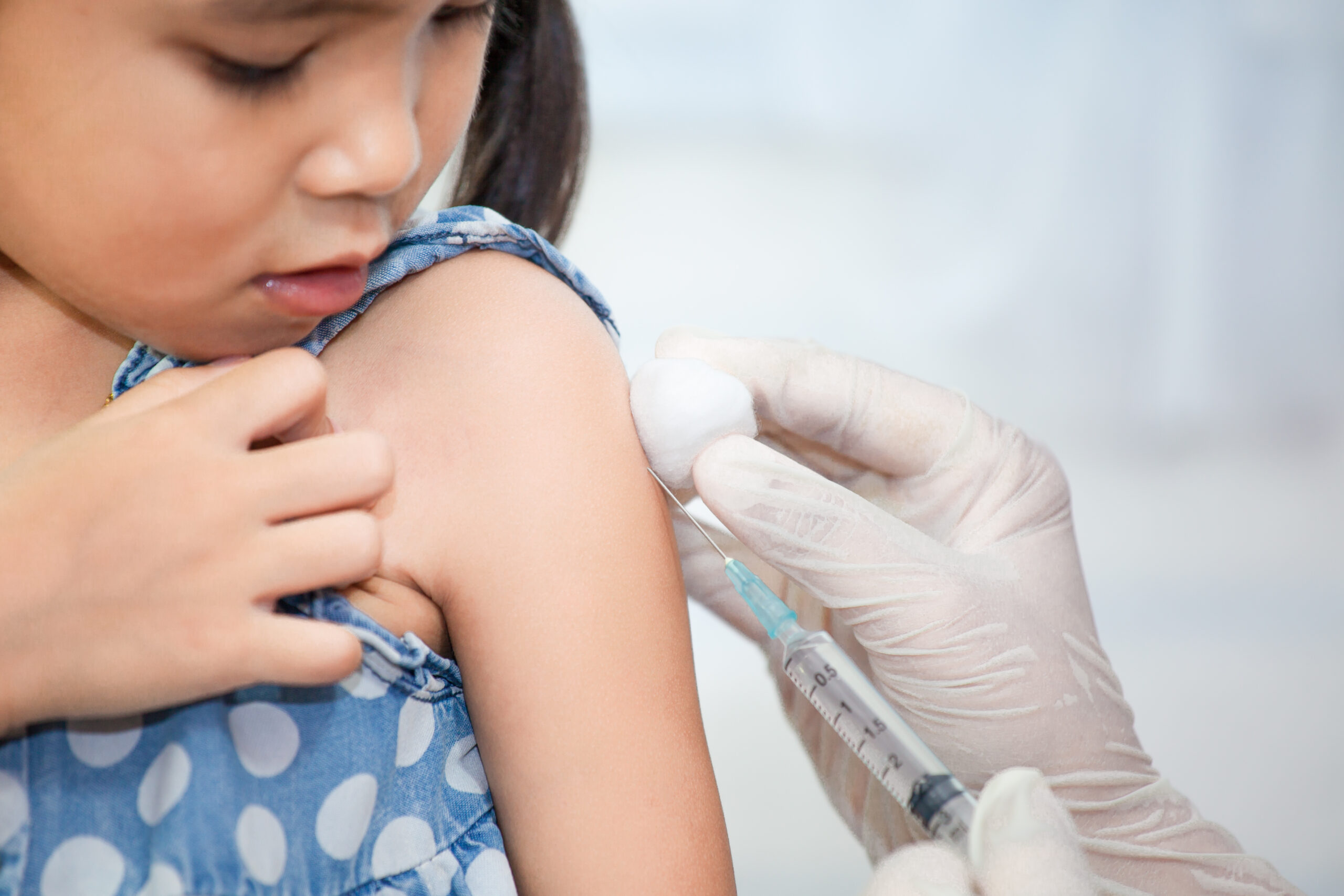 Doctor giving a young child a vaccination
