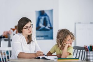 Child doing homework with a tutor
